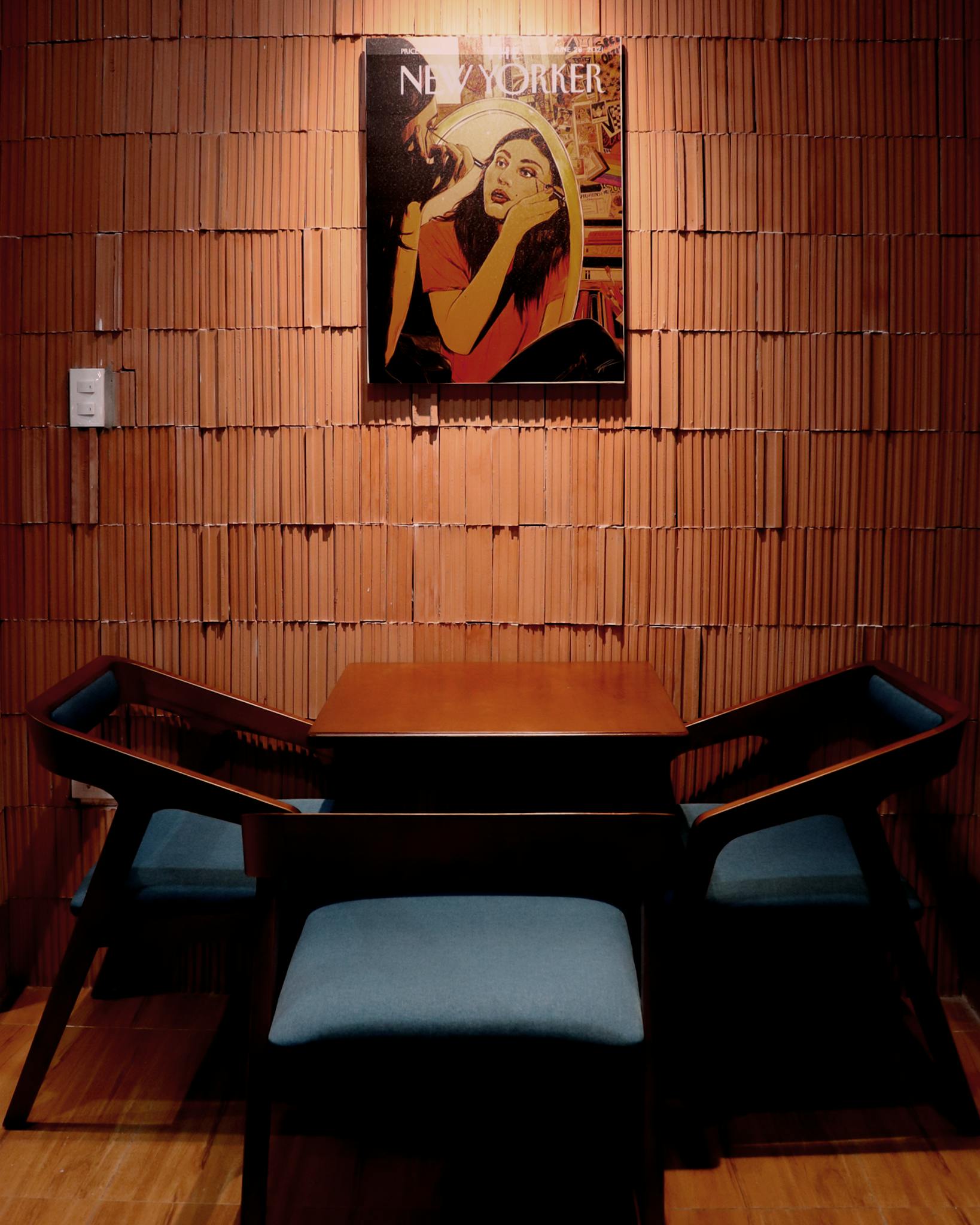 Stylish dining area with a New Yorker poster and elegant chairs, perfect for modern interiors.